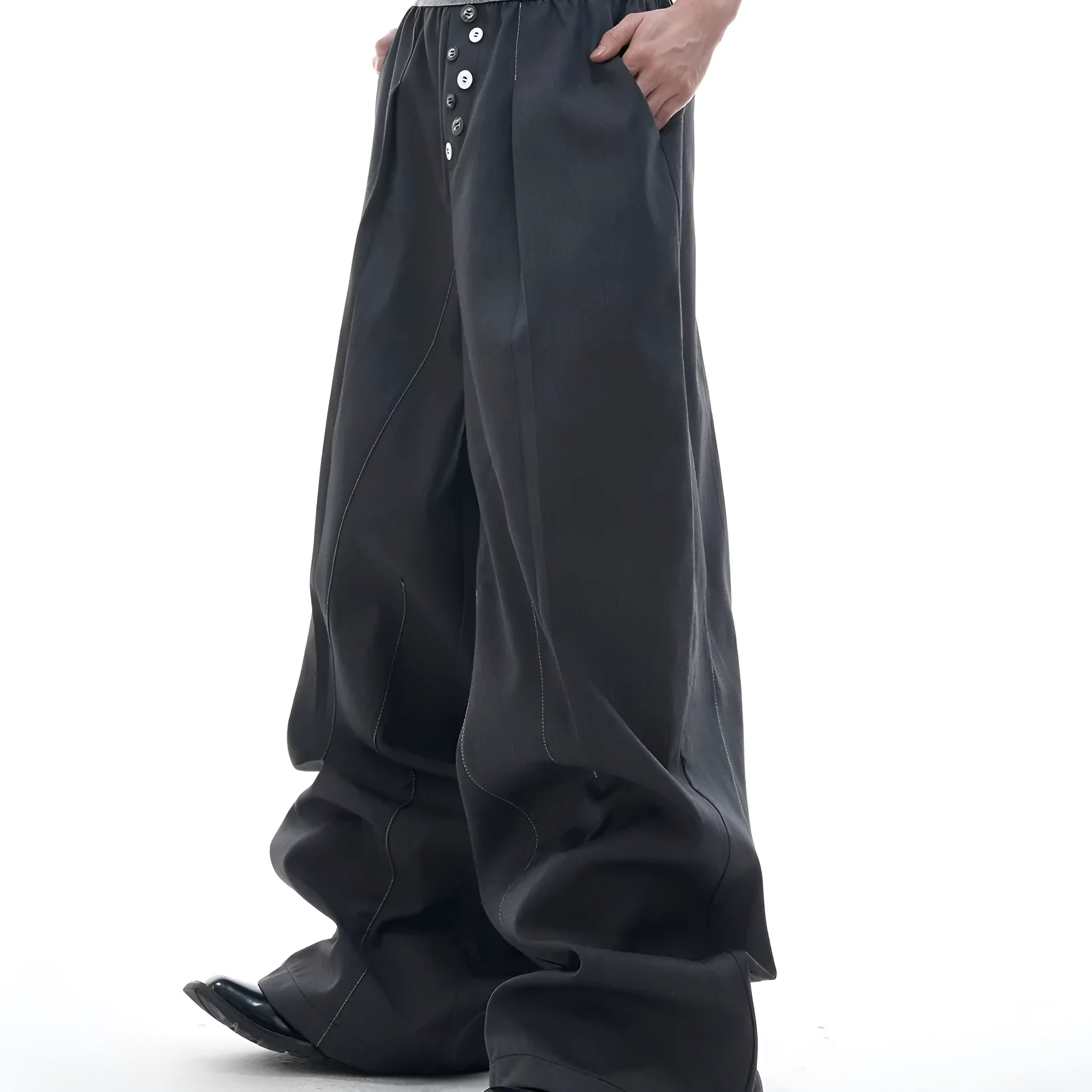 A pair of high-waisted straight-leg casual trousers in grey, showing the button-fly detail.