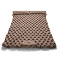 Double camping air mattress inflated, showing widened design and colour options including army green and dark blue.