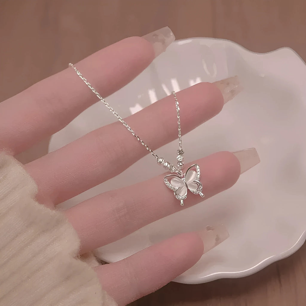 Silver colour 925 silver butterfly opal pendant necklace on an adjustable cross chain.