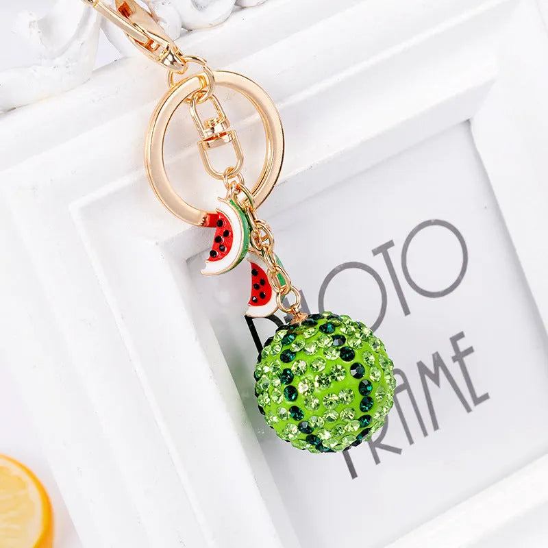 Green zinc alloy watermelon slice keychain measuring 12cm in length.