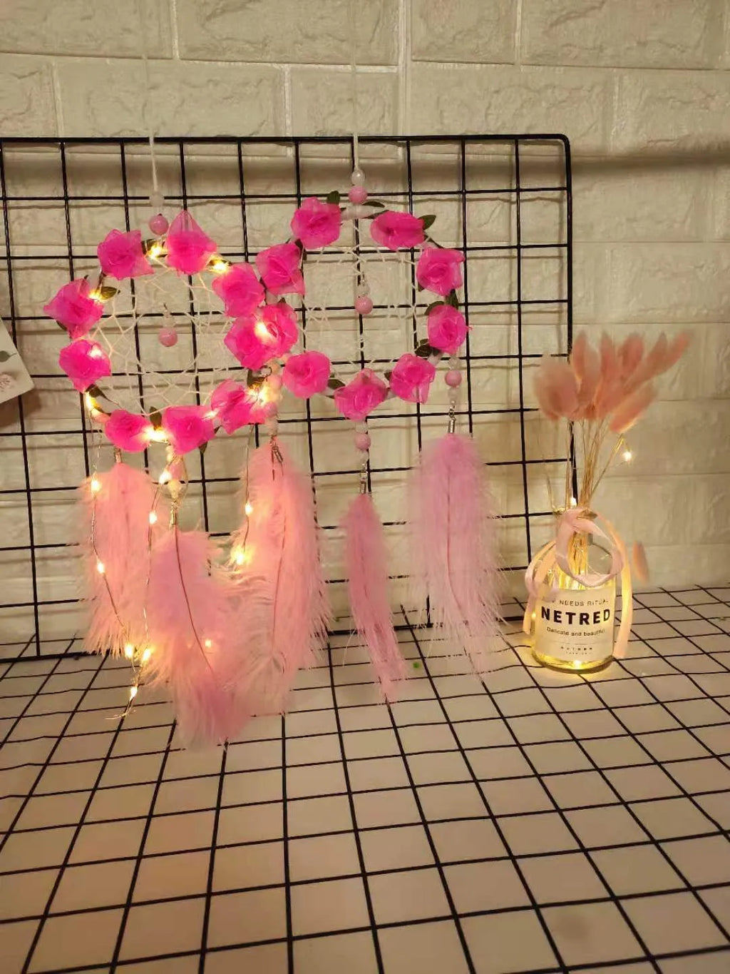 Pink ostrich feather dreamcatcher wall decoration ornament measuring 10cm.