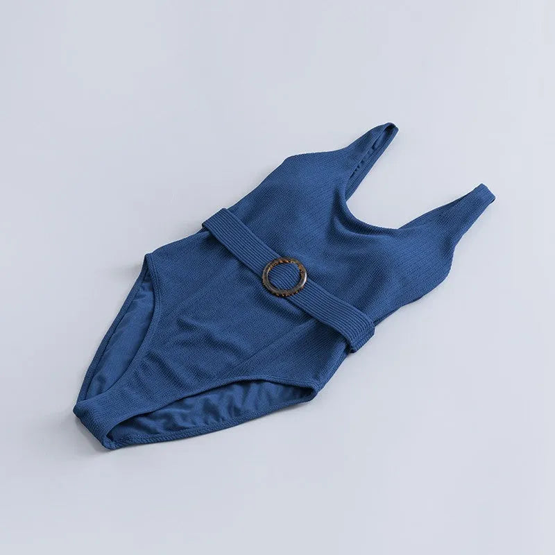 Navy blue women's one-piece swimsuit with triangle cut and chest pads on size chart