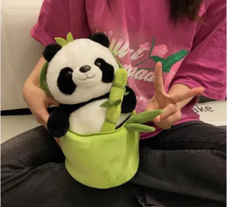Black and white panda plush doll holding a simulated bamboo tube, a soft decorative cushion.