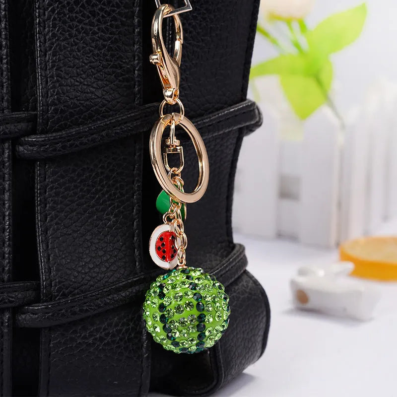 Green zinc alloy watermelon slice keychain measuring 12cm in length.