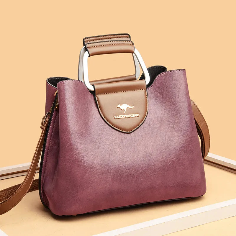 Women's barrel crossbody shoulder bag in soft PU with zip pocket and document pocket, shown in one of six colours