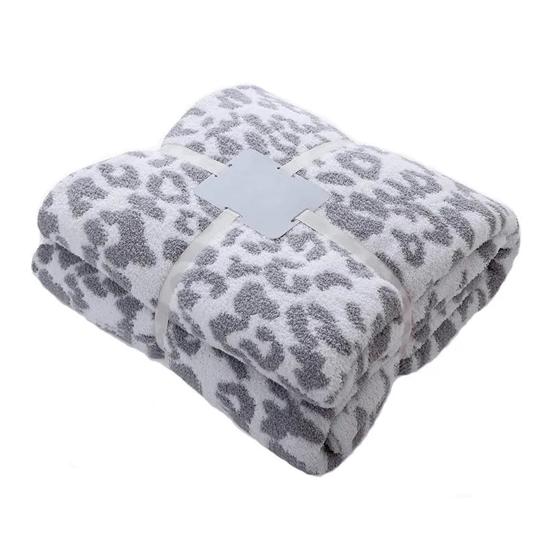 Half velvet leopard print knitted blanket in gray on a sofa, size 130x150cm