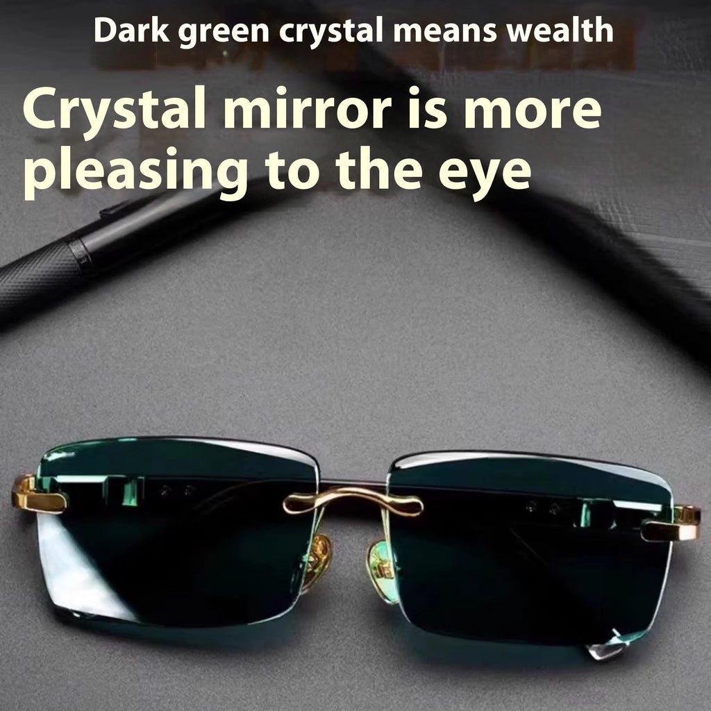 A pair of frameless sunglasses with dark green crystal lenses, shown with a hard protective case and a microfibre cleaning cloth.