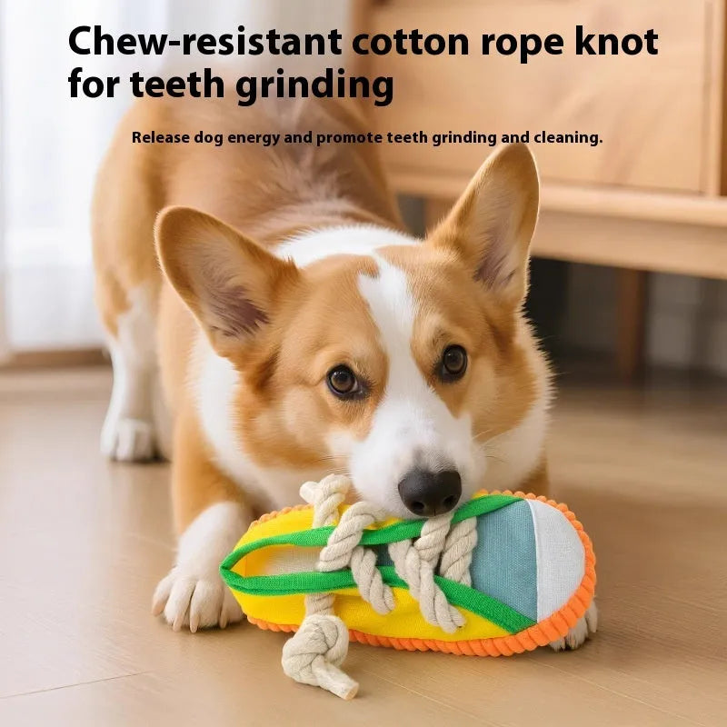 Yellow plastic dog toy shaped like a slipper with a squeaker for chewing.