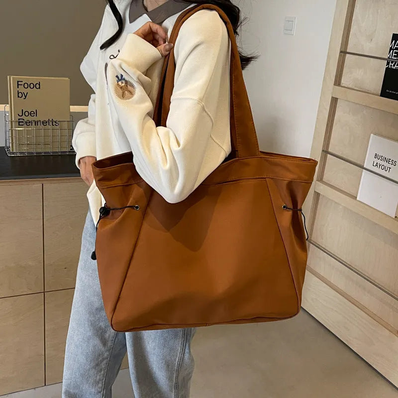 Soft Oxford cloth folding tote bag in five colour options showing shoulder carry design