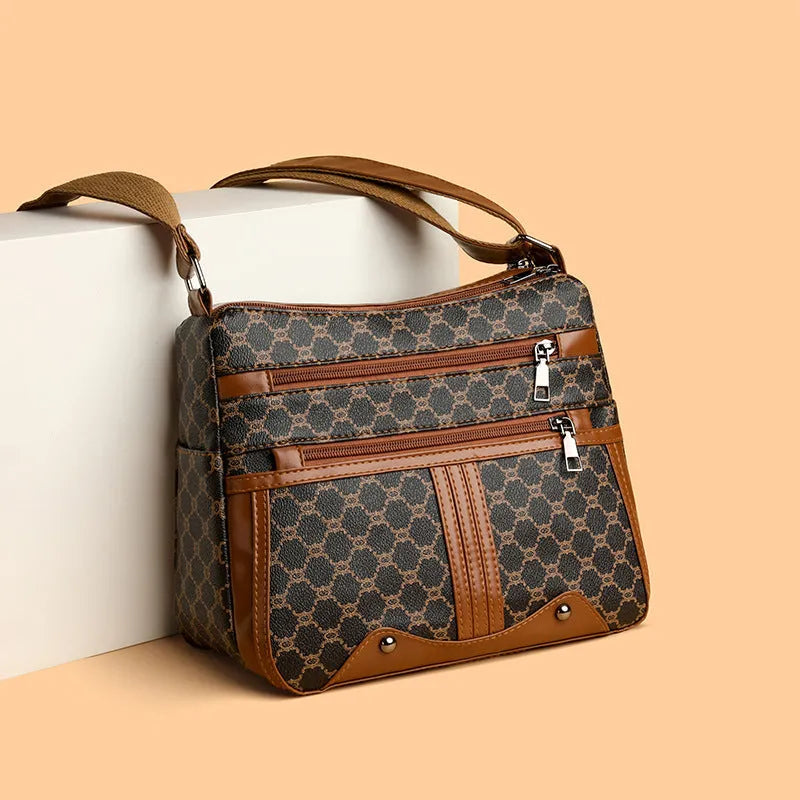 Women's brown and white stitching pattern large-capacity crossbody bag made from PU leather.