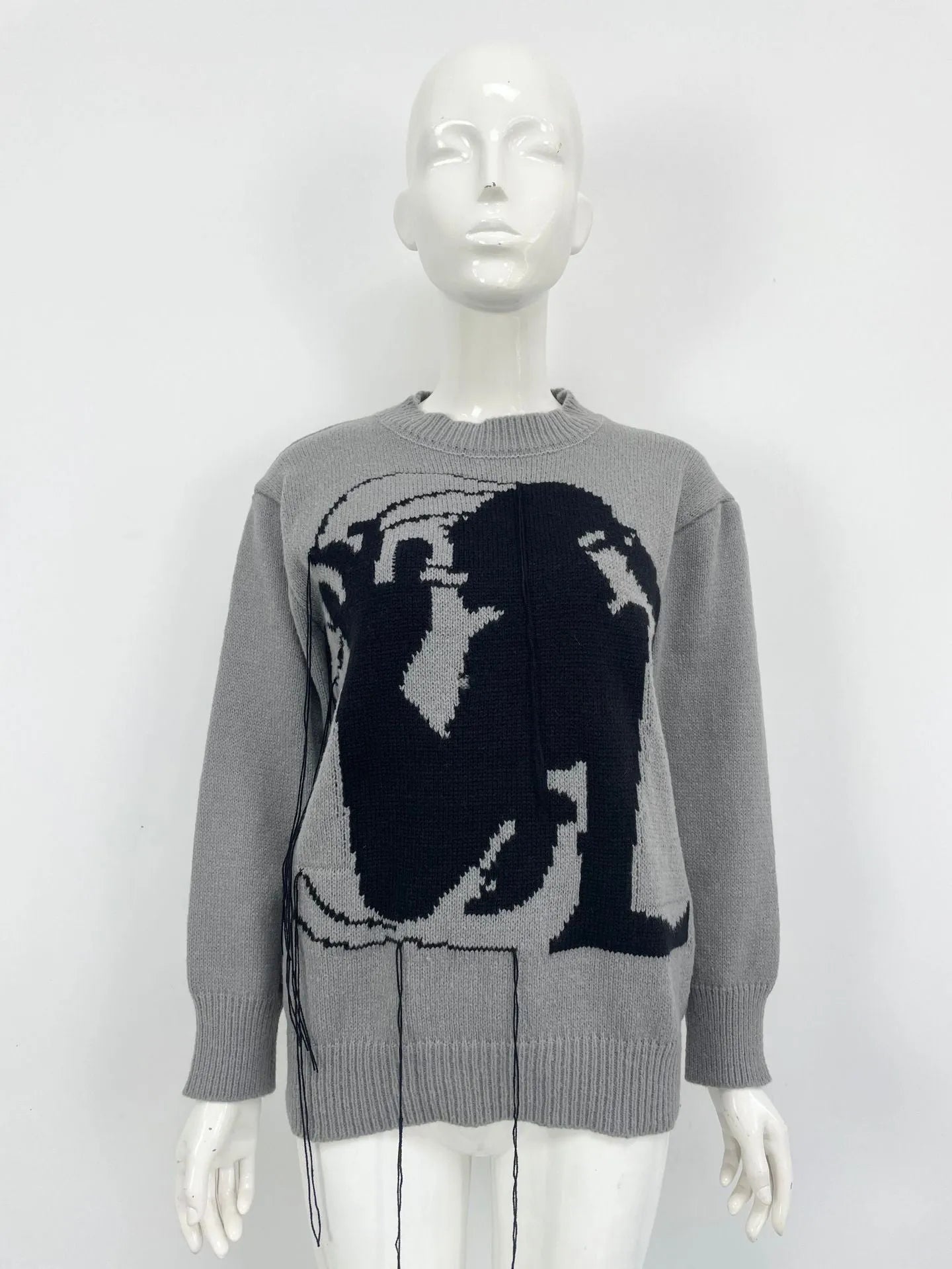 Grey women's loose alpaca wool sweater with tassel detailing and abstract pattern
