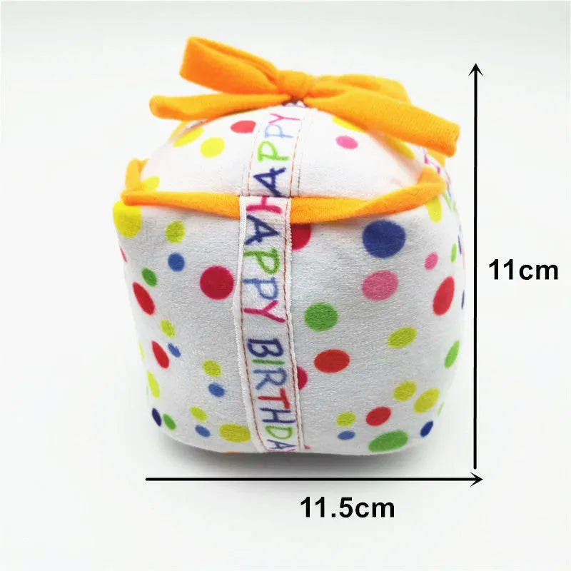Four soft plush dog birthday toys: large cake, small cake, gift box, and bones on neutral background