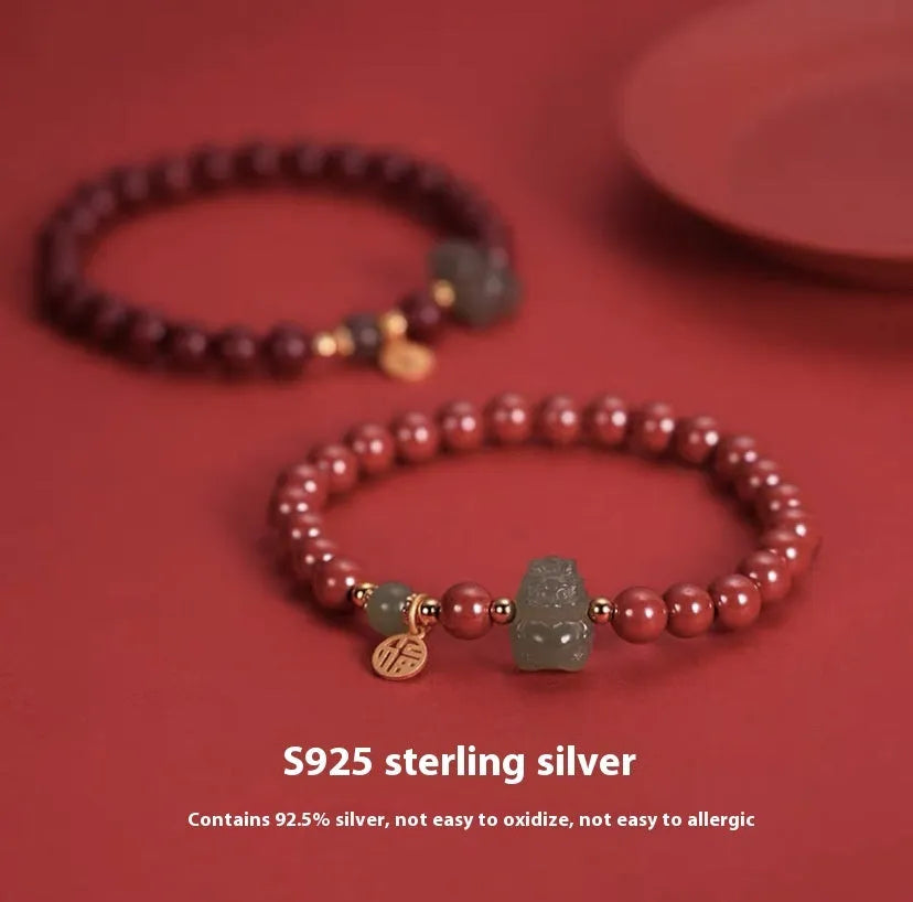 Hand-carved Hetian jade bracelet with animal zodiac designs in 8mm bead size