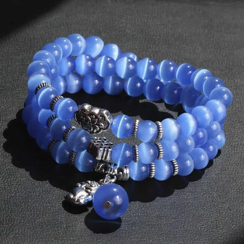 Opal crystal bracelet with geometric cat eye design showing three wraps around wrist