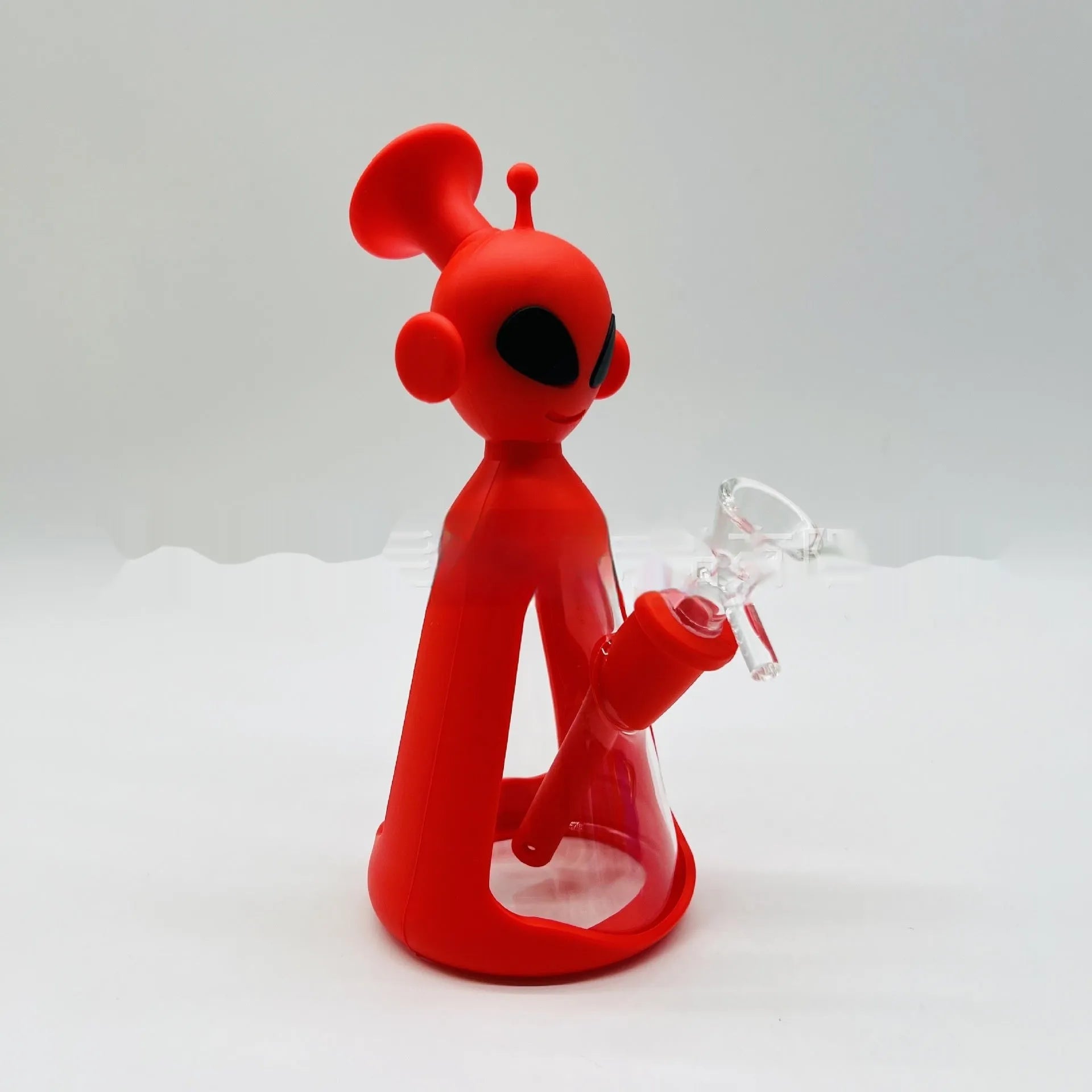 Glass silicone cigarette pipe with clear bowl and blue silicone mouthpiece on white background