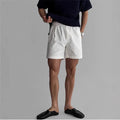 A pair of loose-fit cotton sports shorts in khaki colour on a mannequin, showing the casual summer style.