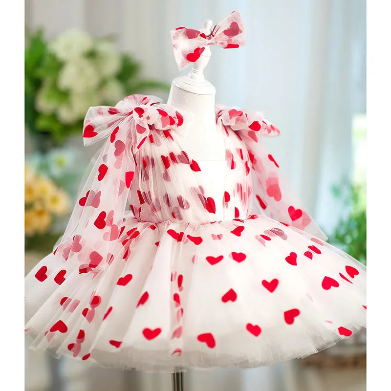 Children red love princess dress gown with heart print on light background, front view
