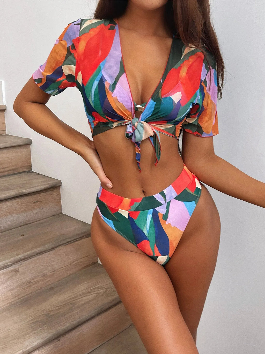 Red women's split-style swimsuit with a printed pattern, for swimming and surfing.