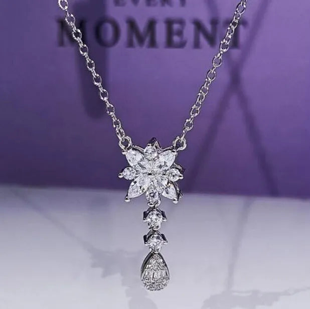 Floral zircon bridal jewellery set including ring, necklace with curb chain, and earrings on brass