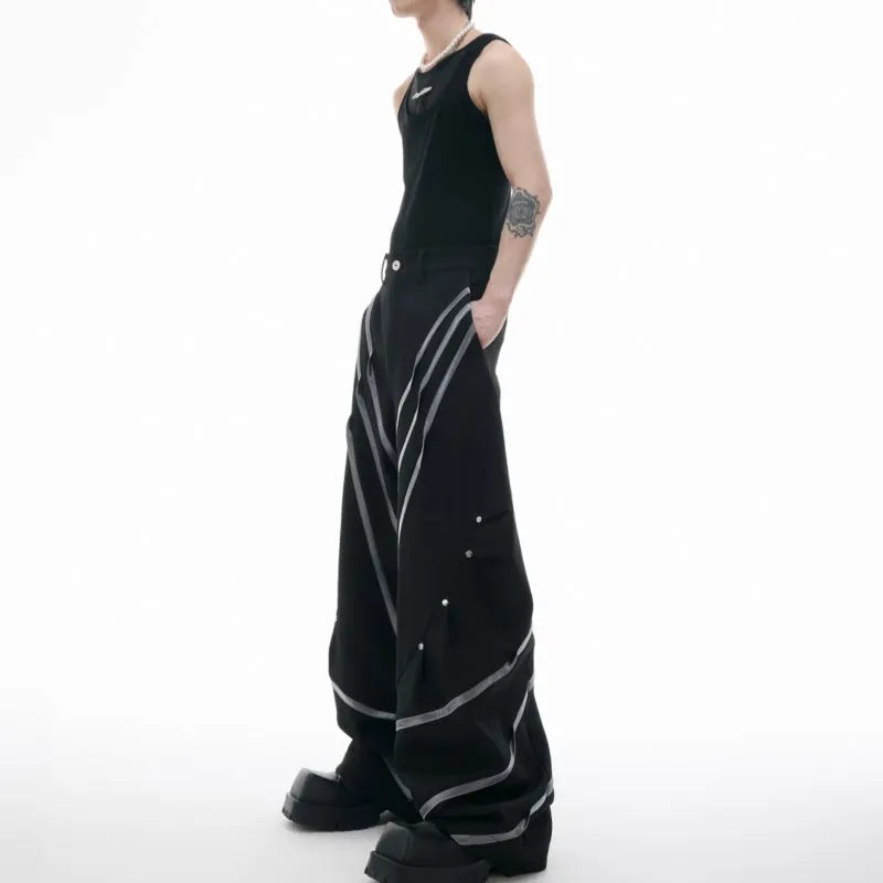 Men's black trousers with metal striped rivet and pleated detail on a three-dimensional cut.