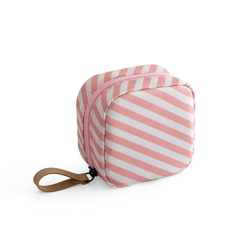 Cloth cube makeup storage bag in blue, pink, white, and white pink colours with a plain pattern.