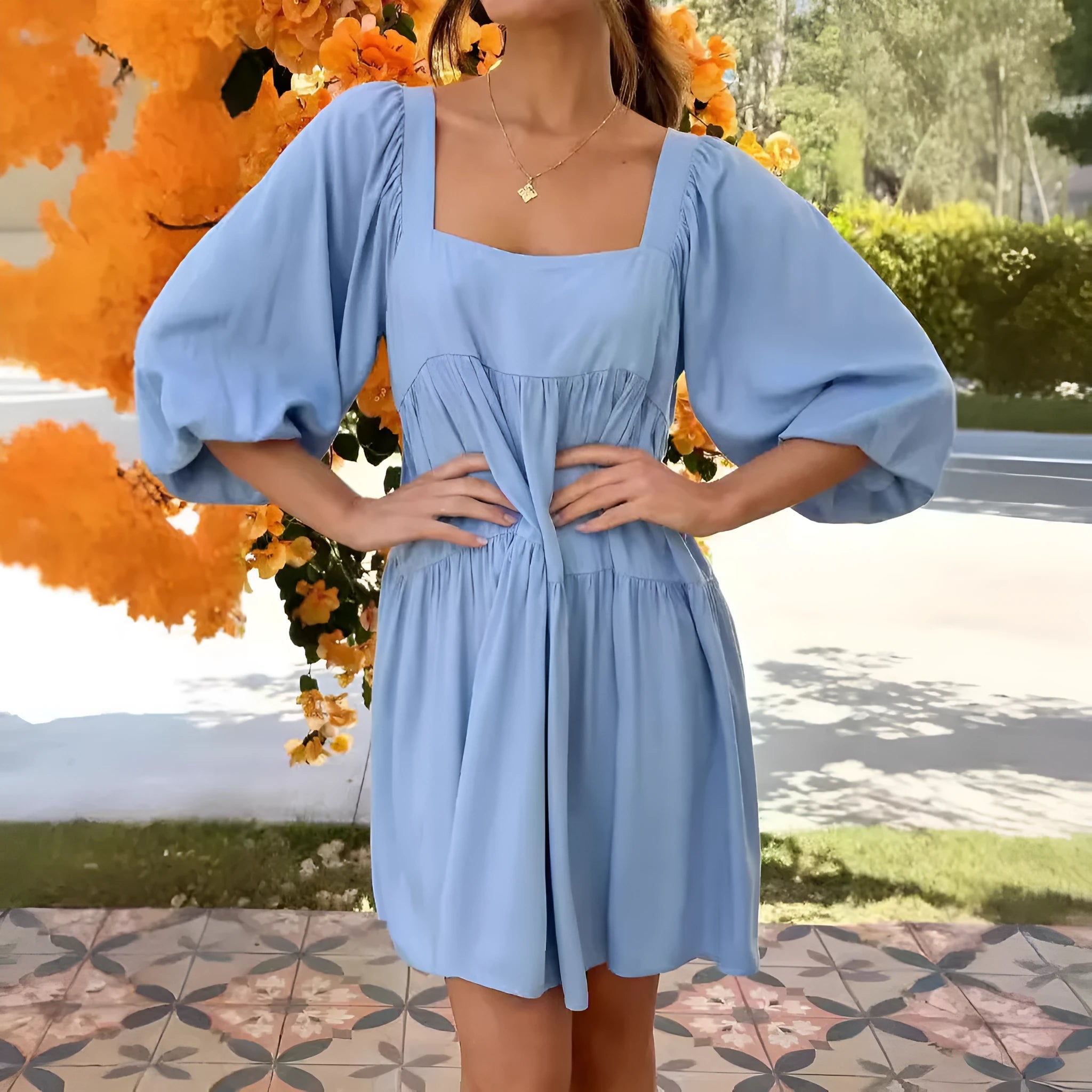 Orange children's backless dress with square collar and puff sleeves on a hanger.