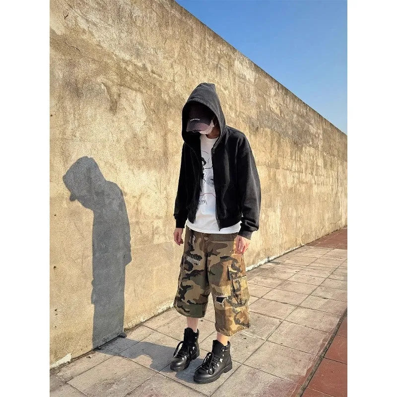 Men's loose-fit camouflage cropped jeans with ripped and patch details on a straight-leg.