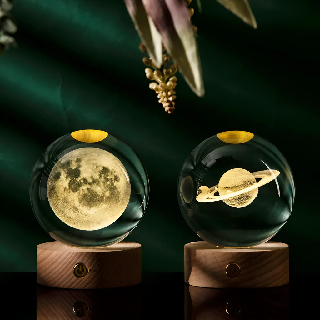 Transparent crystal ball with 3D laser inner carving galaxy design on a beech wood touch light base, warm light glowing