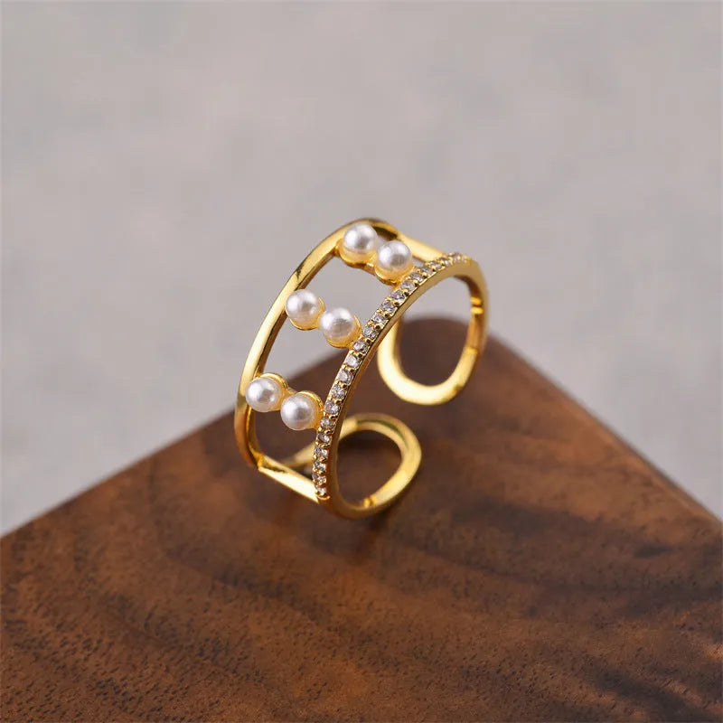 Gold geometric open adjustable ring made from copper with electroplated finish.