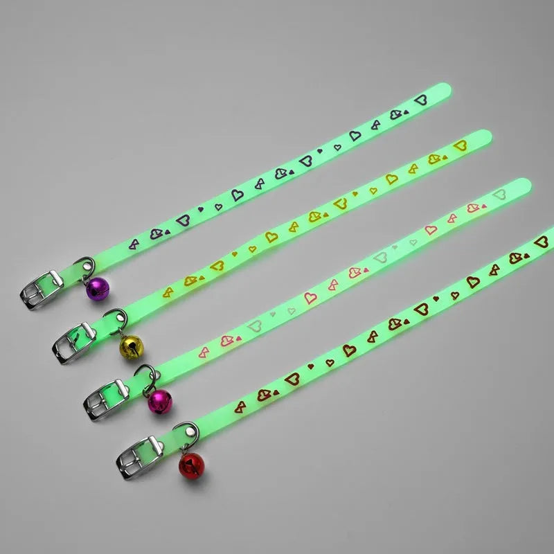 Silicone light-up cat collar with luminous fish bone and heart patterns on a pink background