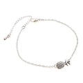 Close-up of a women's alloy bracelet with a detailed pineapple charm in gold or silver colour.