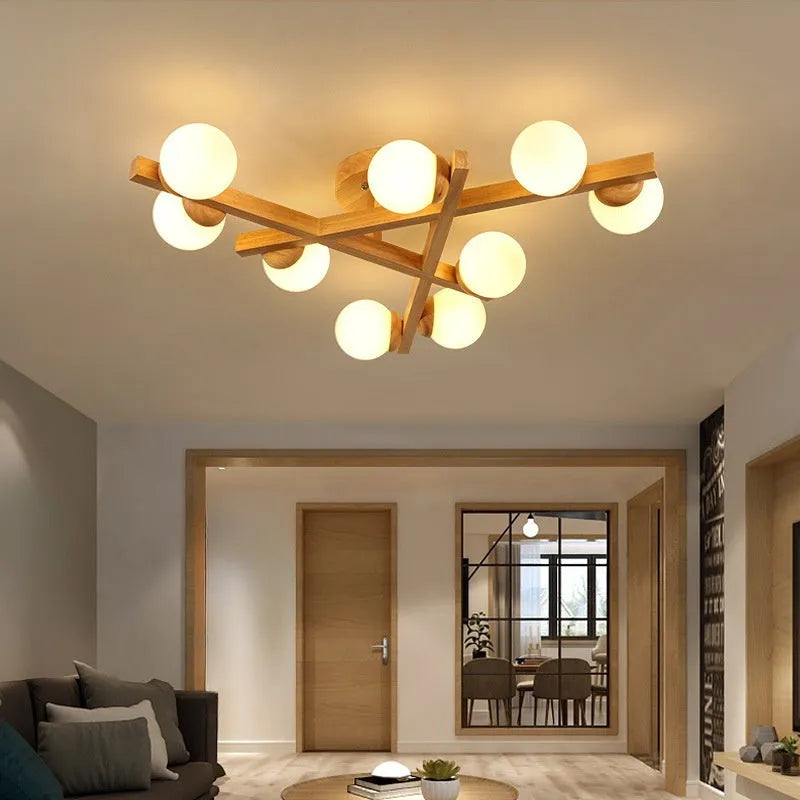 Modern Nordic-style wooden ceiling light fixture with three adjustable lamp heads mounted on a living room ceiling.