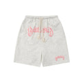 Men's black cotton loose-fit street style cropped shorts on a grey background.