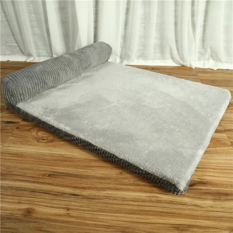 Corduroy bolster dog bed in grey colour, showing its non-slip base and high sides.