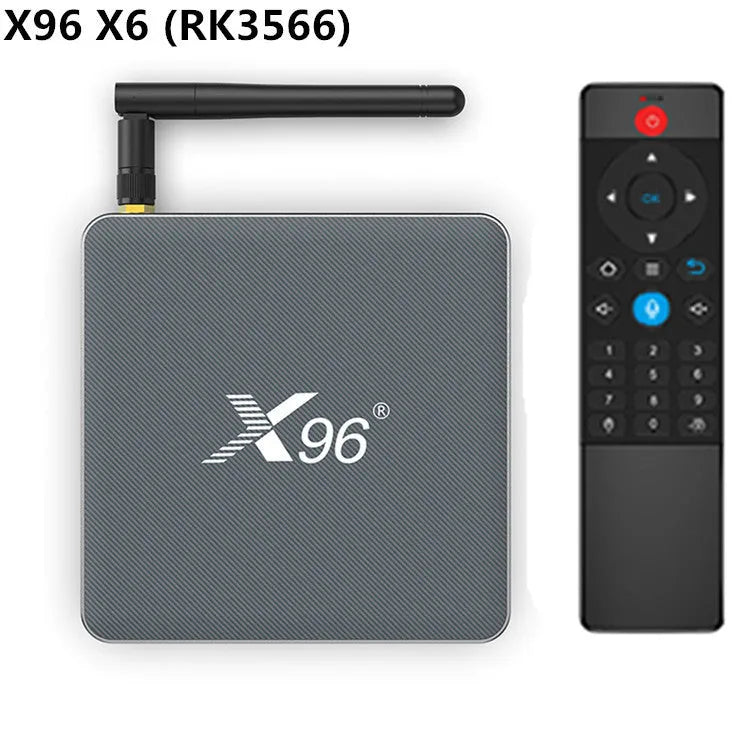Android Smart TV set-top box with voice remote, HDMI cable, and power adapter on a table.