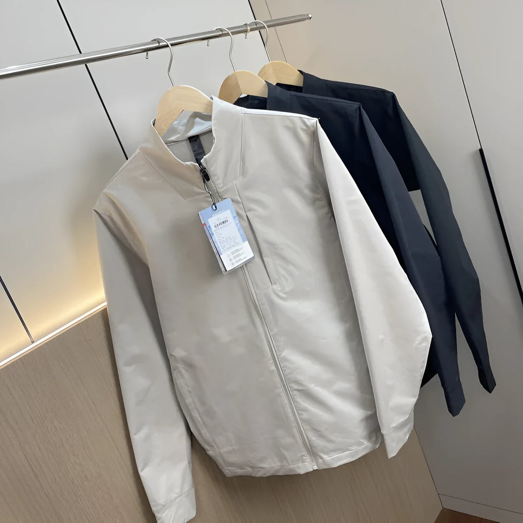 Man wearing a milky white stand collar casual jacket with long sleeves and a straight hem.