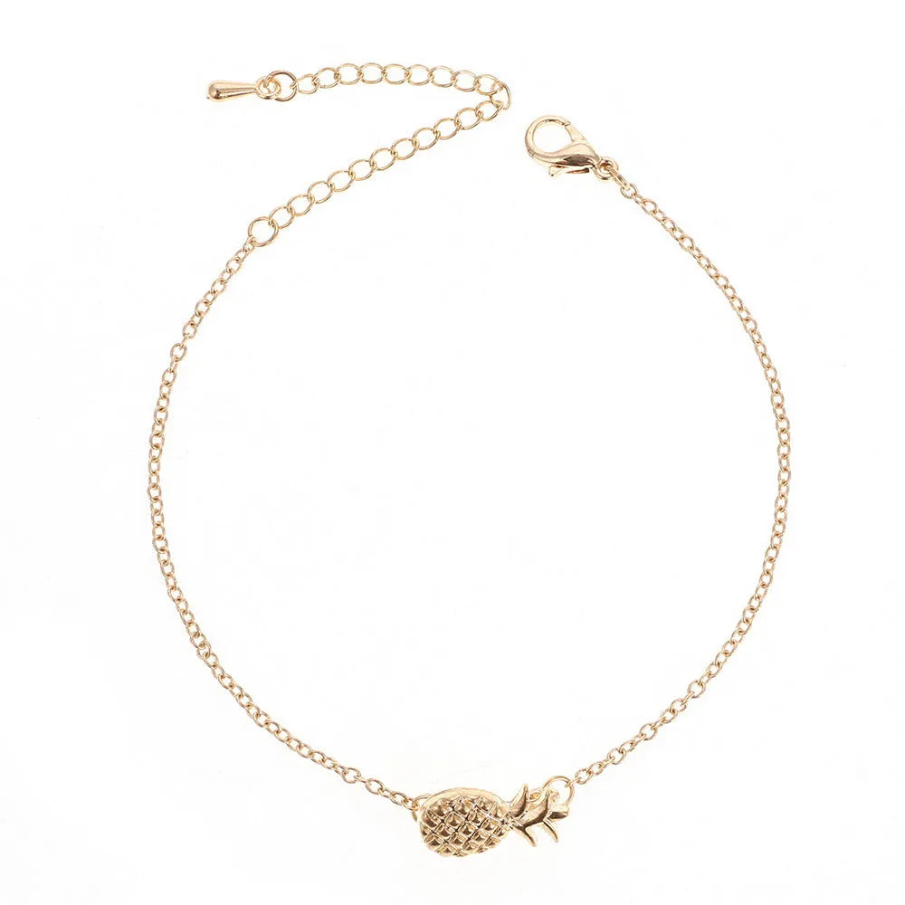 Close-up of a women's alloy bracelet featuring a detailed pineapple charm in gold or silver colour.