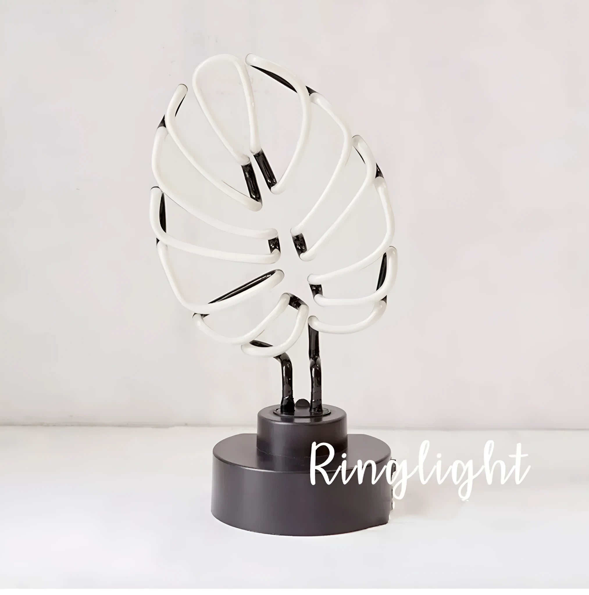 Minimalist white bamboo-shaped desktop lamp with a green glow, shown in two size options.