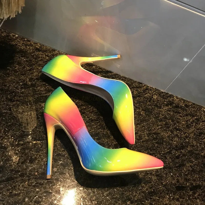 Rainbow coloured patent leather high heel shoes with a pointed toe and a thin stiletto heel.