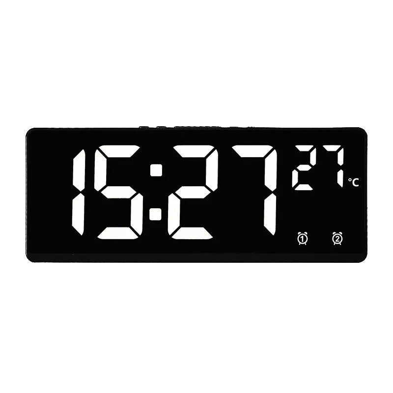 Electronic alarm clock with large LED screen showing time and temperature on desktop