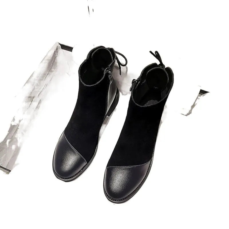 Black women's knee-high martin boots with side zipper and round toe on a rubber sole.
