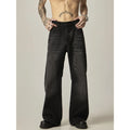 Black loose-fit straight leg denim jeans with a zipper fly on a neutral background.