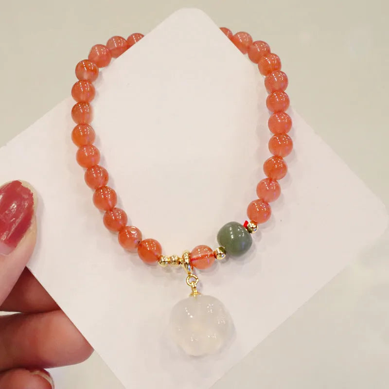 Women's red agate bracelet with 6mm beads and 8mm cat's paw design element
