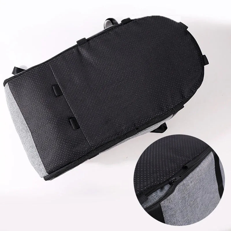 A grey cloth outdoor dog kennel set up in a garden, showing its open front and mesh panel.