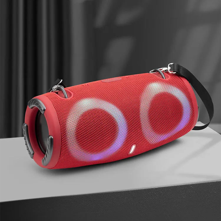War Drum portable Bluetooth speaker with coloured RGB lights in camouflage colour, showing carrying strap and control buttons.