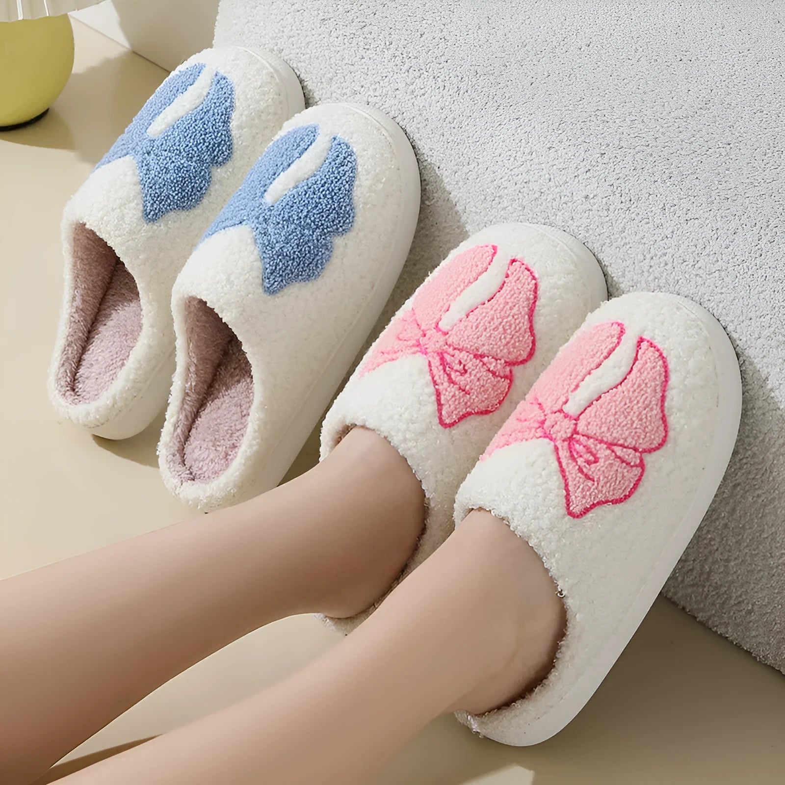 Pink and blue cotton suede slippers with a cartoon bow knot design and TPR sole.
