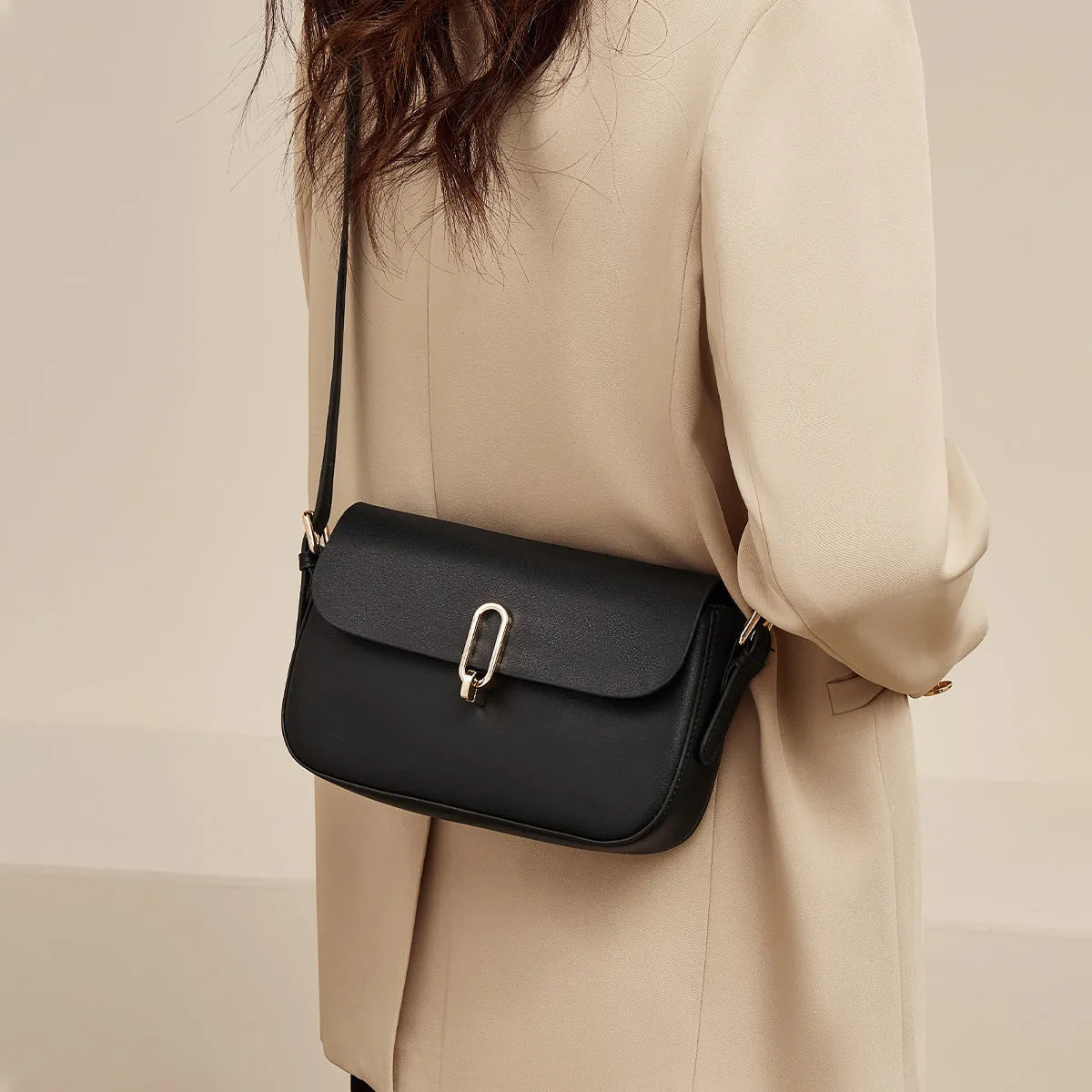 Black genuine leather square messenger bag with shoulder strap and lock closure