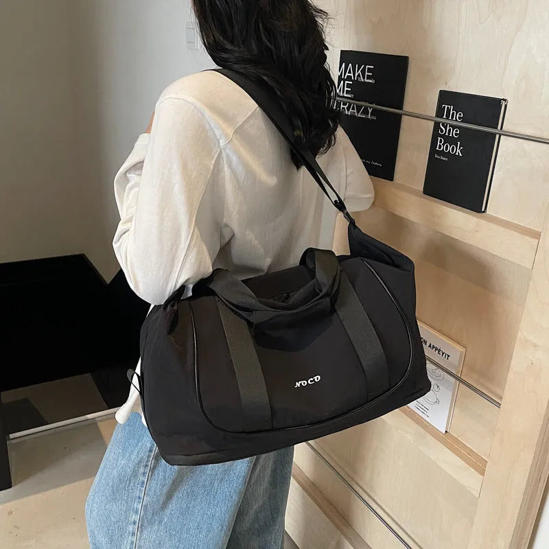 A milky white Oxford cloth crossbody bag for yoga and fitness, shown in a one-shoulder carry style.