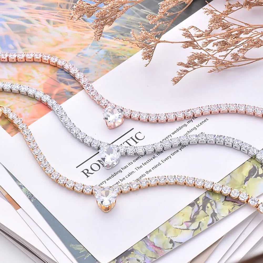 Gold heart-shaped rhinestone dog collar with sparkling stones and a metal clasp.
