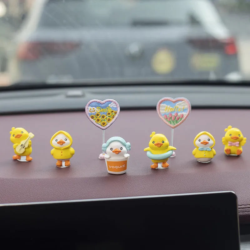 PVC cartoon duckling car decoration set with six ducks and one sign on a car dashboard